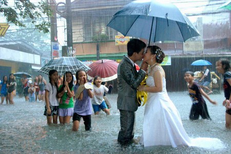 Невеста с женихом целуются под дождем